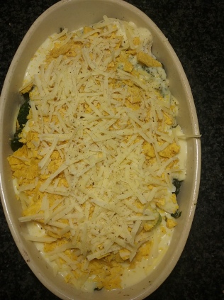 Sprinkle crushed tortilla over the top and cover with grated cheese and black pepper